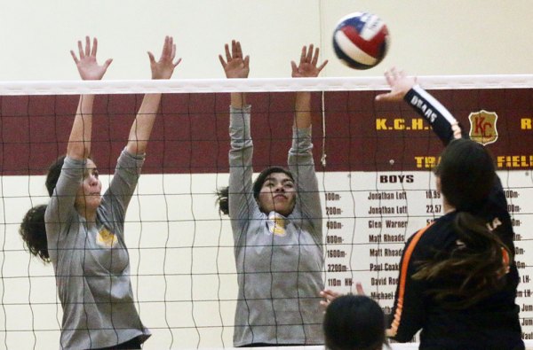 Kings Christian Kylie Pierce and Analeah Facio-Dick block a shot in Tuesday's disappointing CIF Central Section volleyball playoff loss to visiting Selma High School.